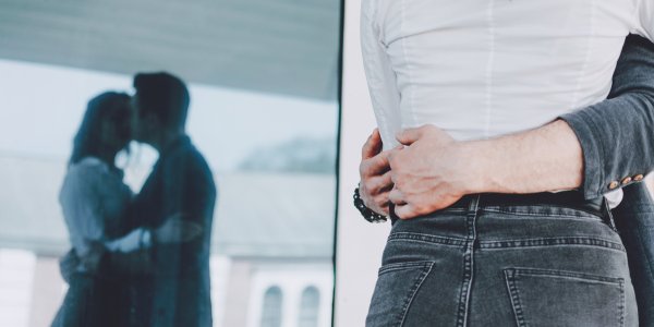 Couple demonstrating the bearhug sex position in a close, affectionate embrace